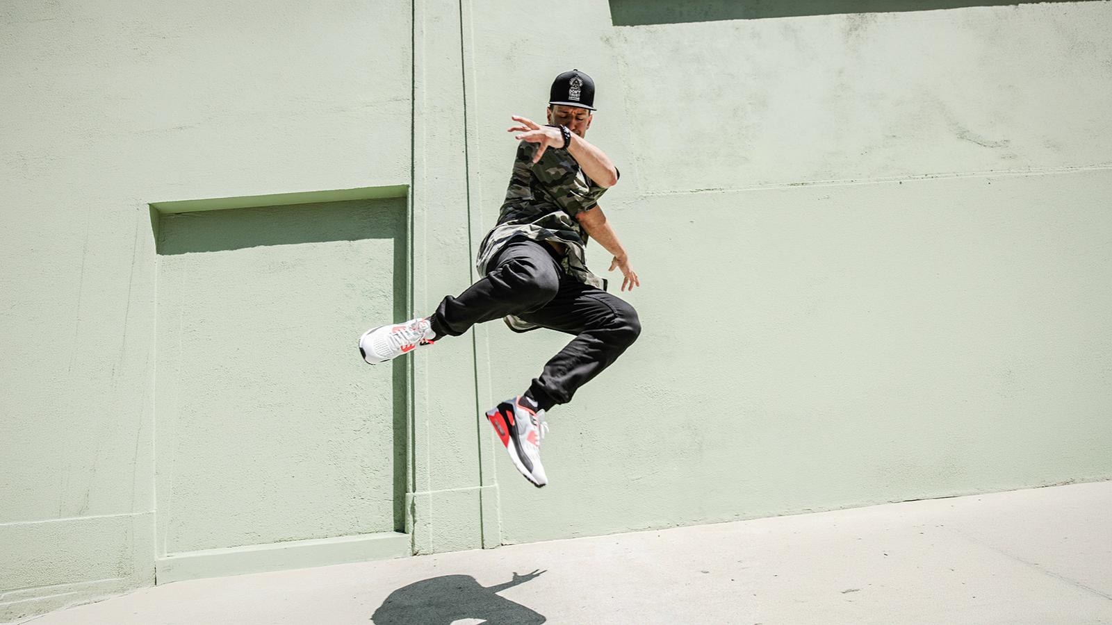 Dancer jumping in the air on a sidewalk