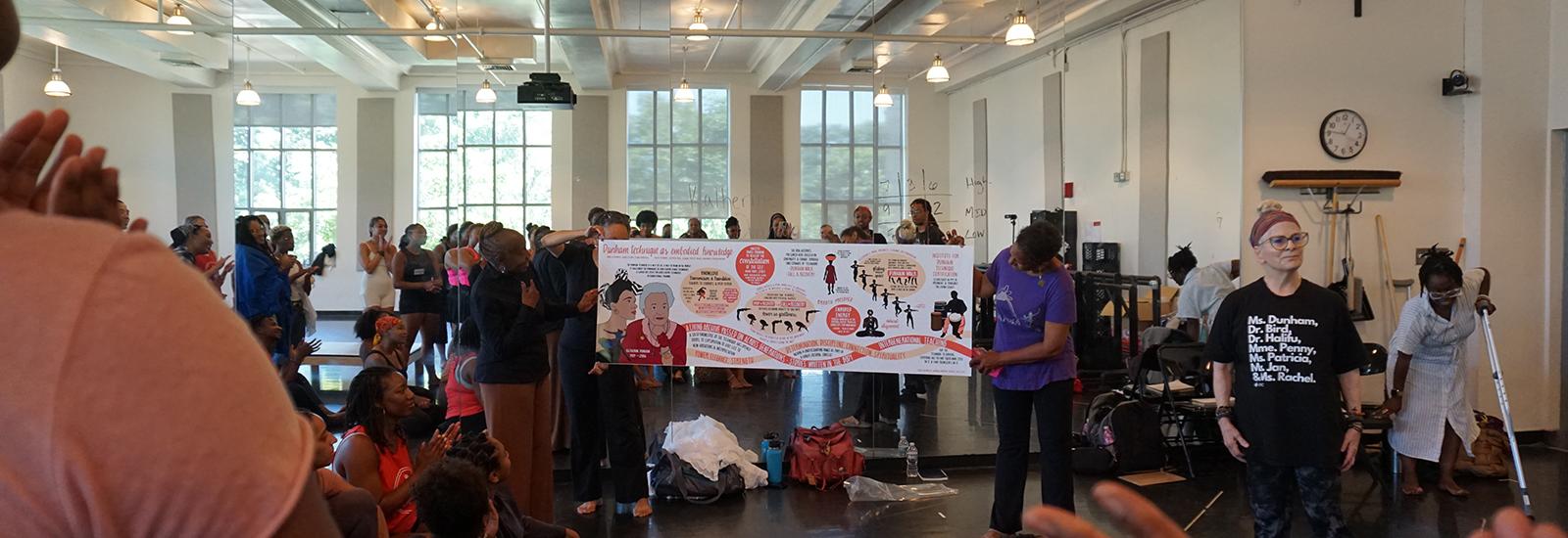 People in a studio looking at a large banner