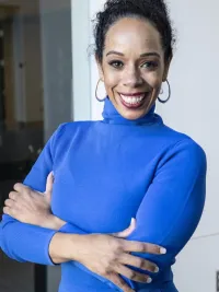 person with black hair wearing blue dress