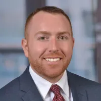 person with short hair wearing a suit