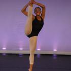 Dancer standing with one leg raised above head