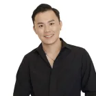 person with short black hair and black long sleeve shirt