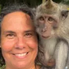 Person with brown hair with monkey on shoulder