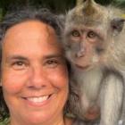 Person with brown hair with monkey on shoulder